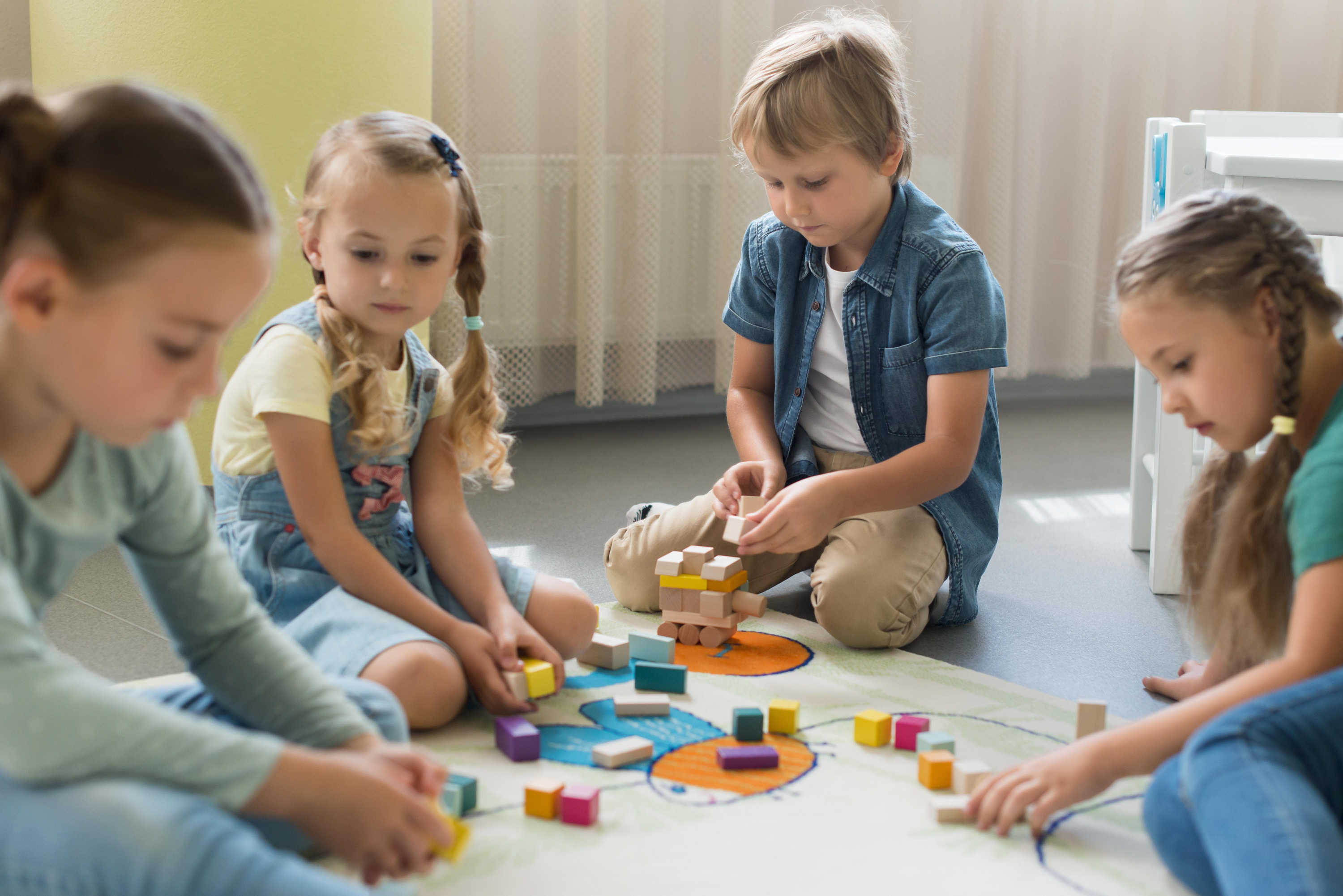 Front view children playing together kindergarten  1 