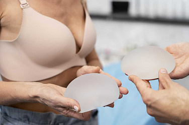 close_up_hands_holding_breast_implants